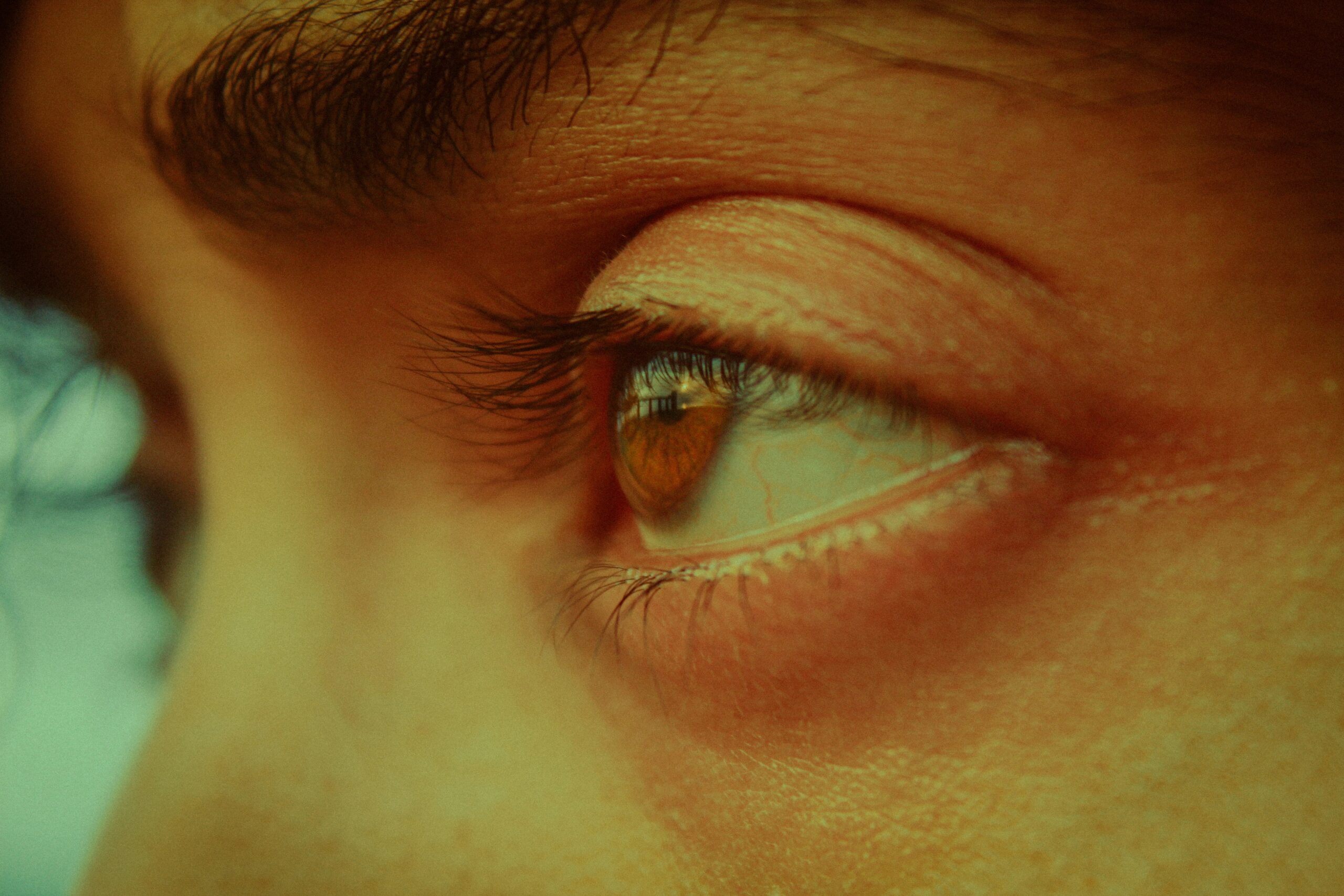 A close-up photo showing smeared mascara around the eyes, highlighting common issues with non-smudge-proof formulas