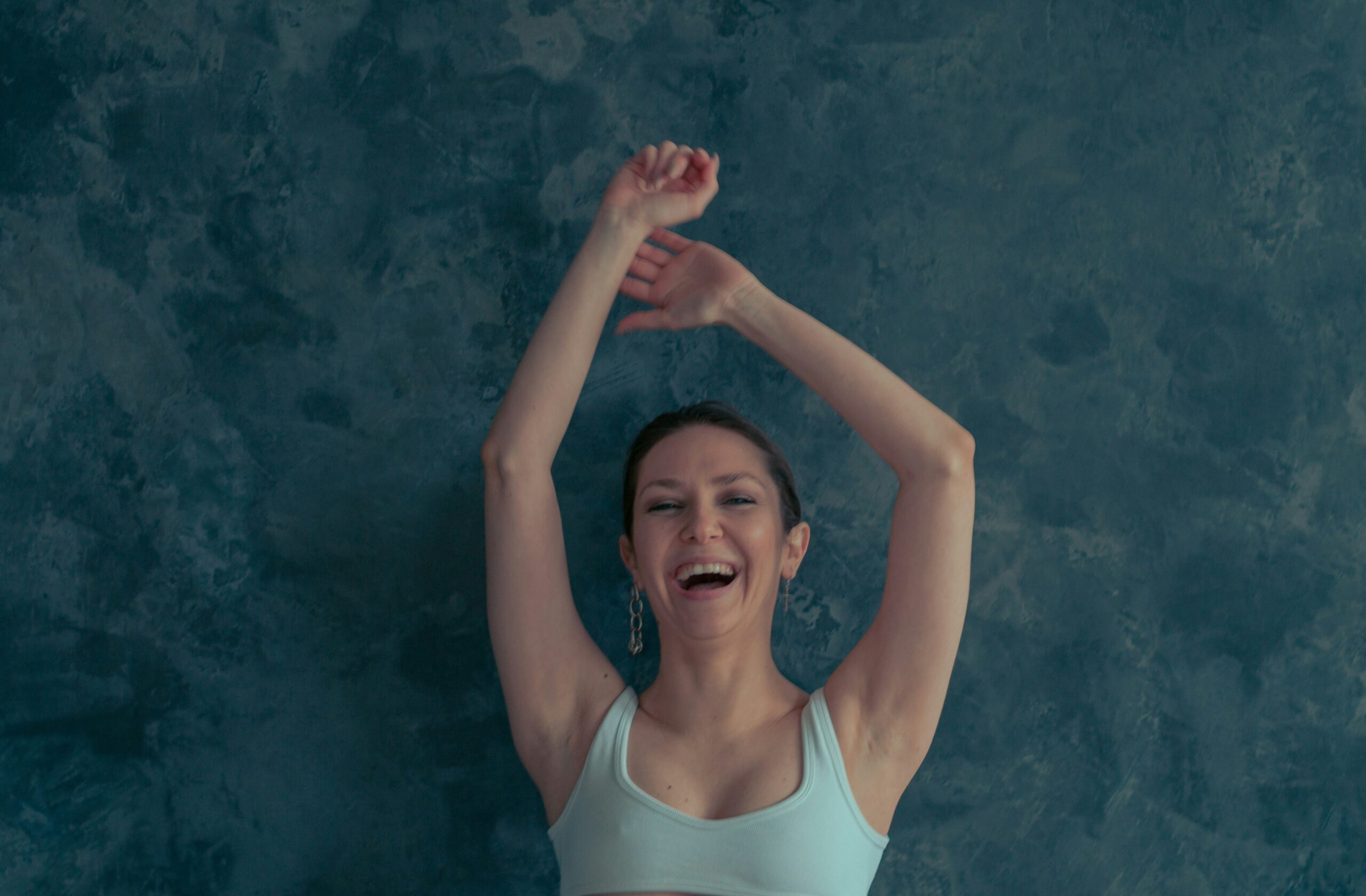 A woman wiping her melting makeup during a workout