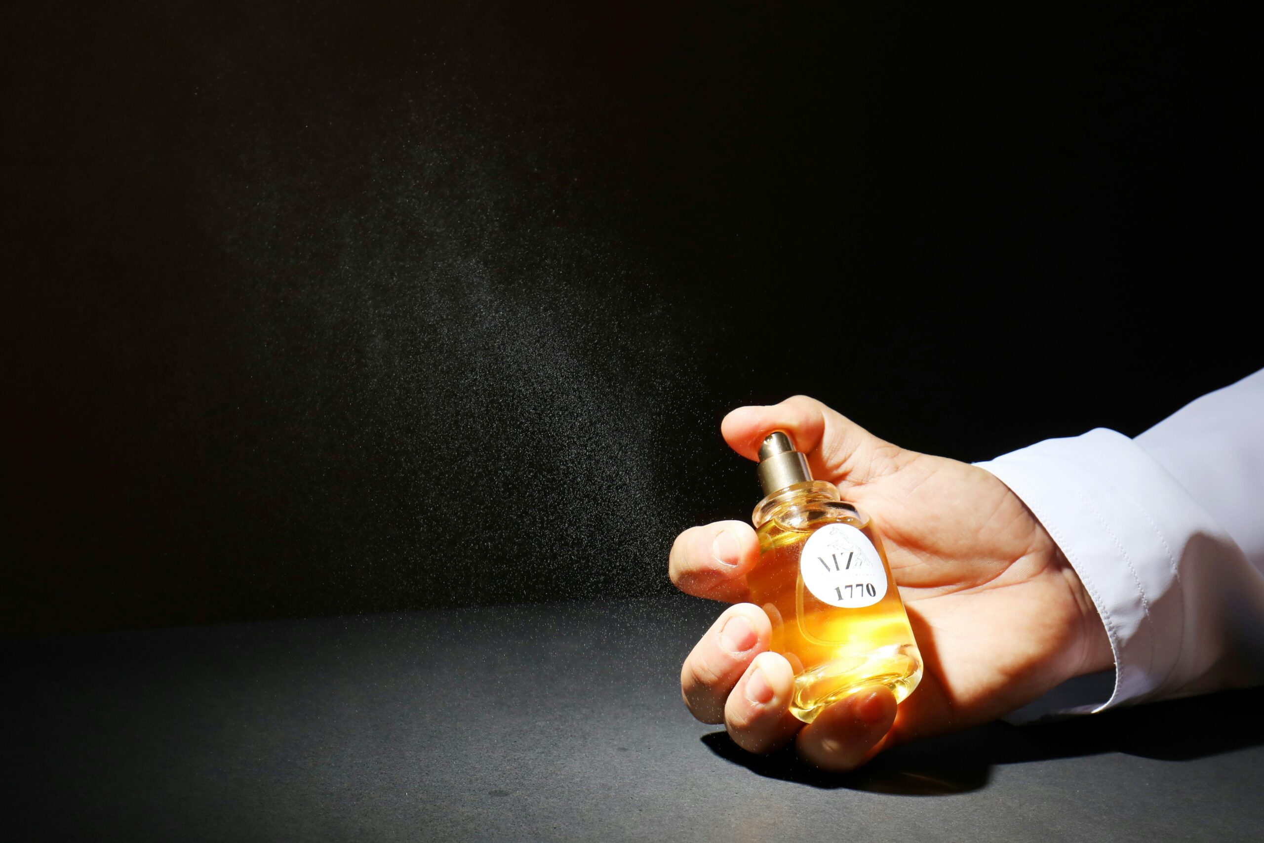 Bottle of Urban Decay All Nighter Setting Spray being sprayed onto hand