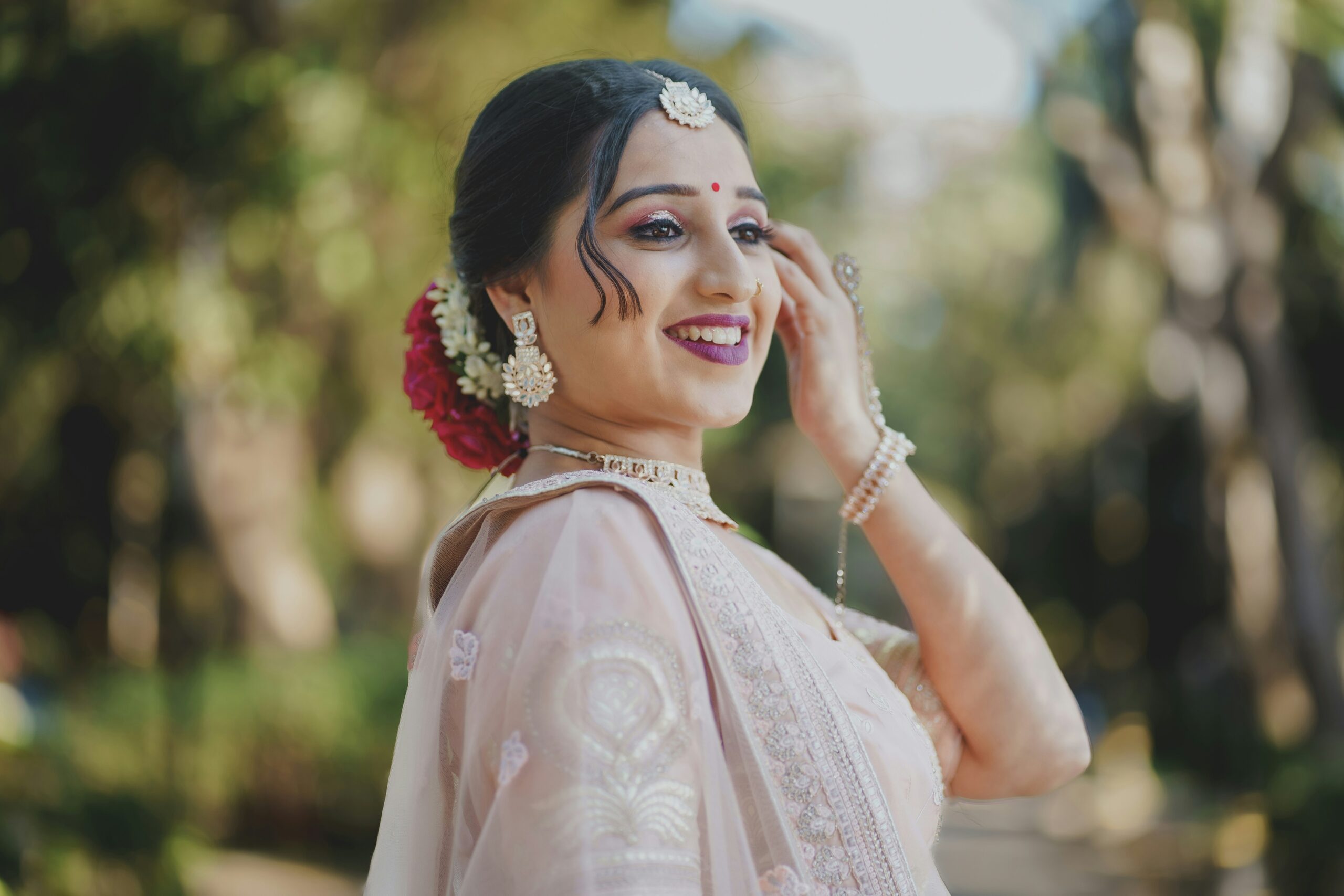 Bride smiling with flawless makeup outdoors