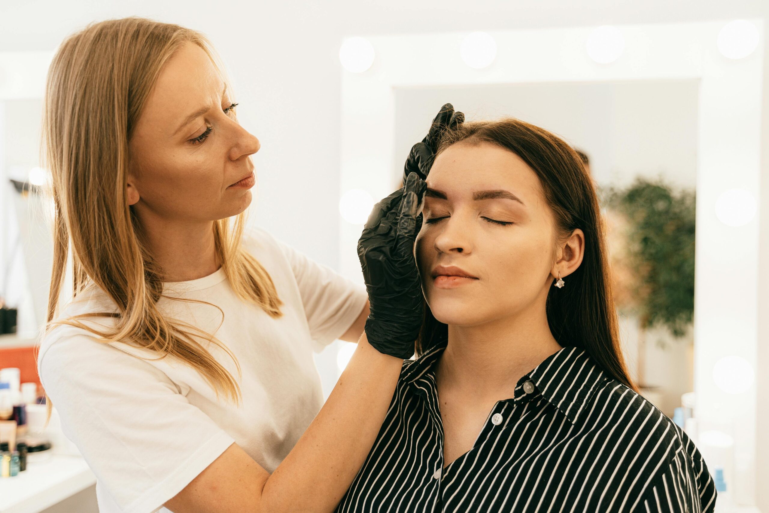 Makeup artist demonstrating waterproof makeup techniques on a model
