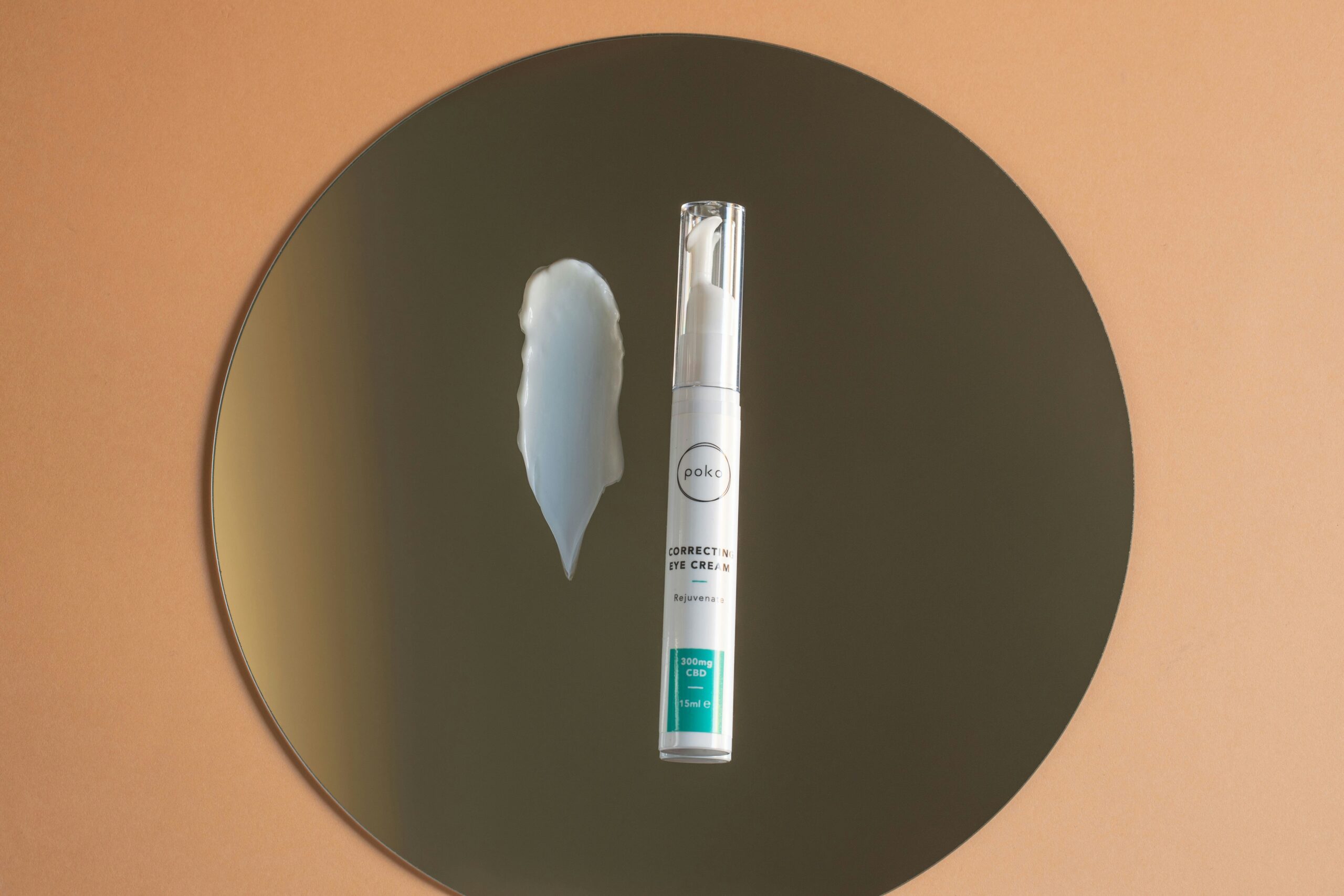 Close-up photo demonstrating step-by-step application of smudge-resistant brow gel using a spoolie brush.