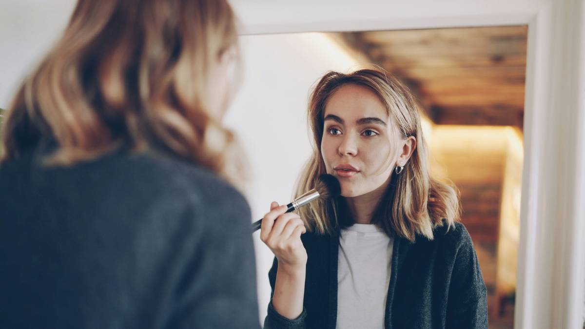 A woman applying waterproof mascara