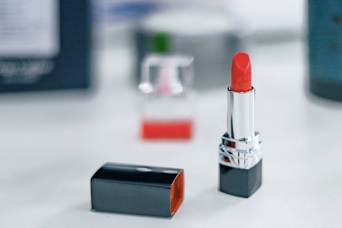 Closeup shot of a woman's lips wearing deep purple lipstick