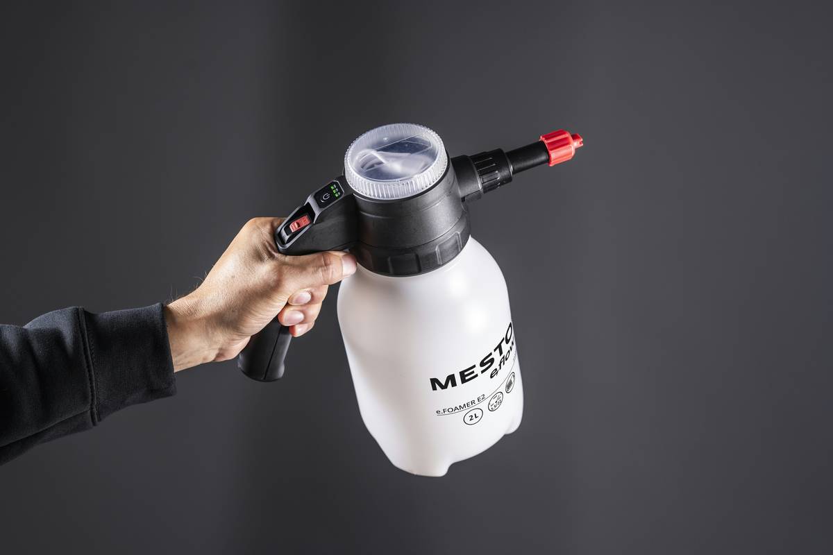 Closeup shot of woman misting setting spray correctly