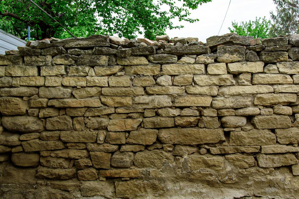 A flat lay featuring waterproof eyeliner, mascara, and lip liner on a marble surface.