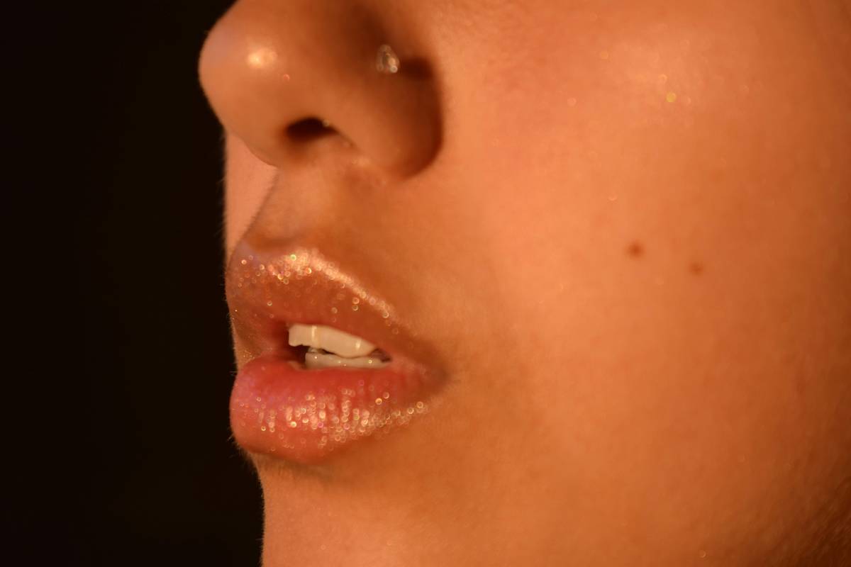 Close-up shot of vibrant lips wearing proof smudge lipstick with no visible transfer marks.