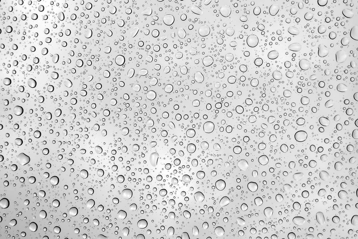 Close-up of waterproof mascara beads repelling water droplets, illustrating what is a waterproof material